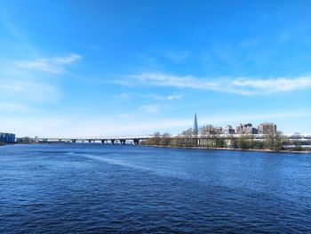 Bridge over river with buildings in background