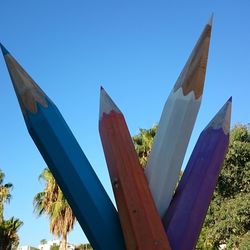 View of trees against clear blue sky