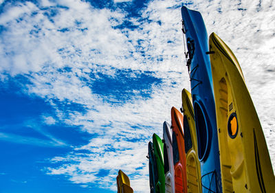 Low angle view of multi colored flag against sky