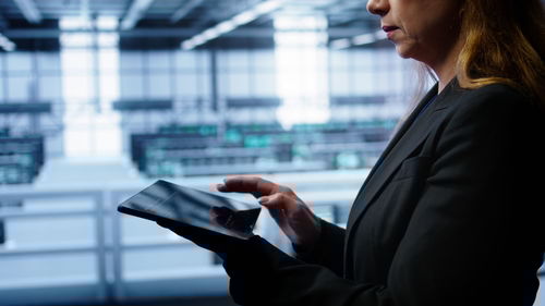 Midsection of businessman using mobile phone