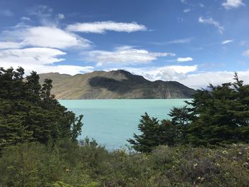 Scenic view of lake and mountains against sky