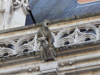 Low angle view of statue against building