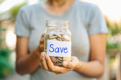 Close-up of man holding glass jar