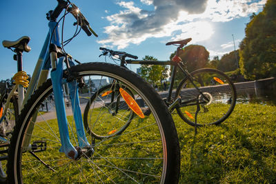 Bicycle parked on field against sky