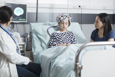 Female doctor examining patient in clinic