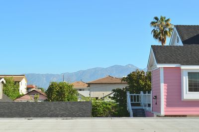 Houses in town against clear sky