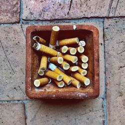 Directly above shot of cigarette in ashtray on table