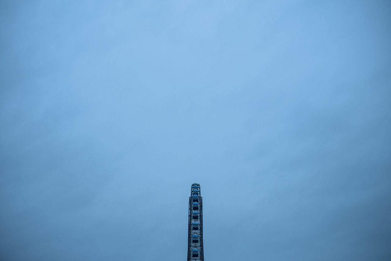 LOW ANGLE VIEW OF BUILDING AGAINST BLUE SKY