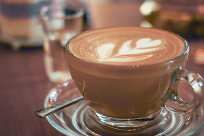 Close-up of cappuccino served on table