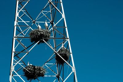 Low angle view of metallic structure against blue sky