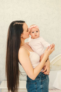 Young woman with daughter in hair