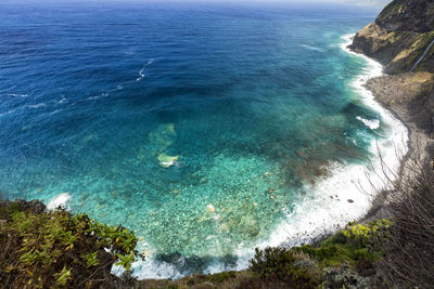 High angle view of sea against blue sky