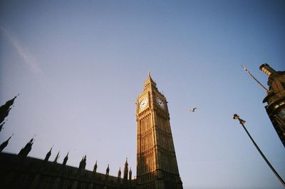 Low angle view of clock tower against clear sky