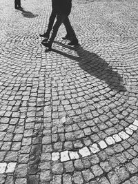 Low section of people walking on street