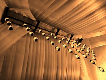 Low angle view of illuminated lights hanging from ceiling