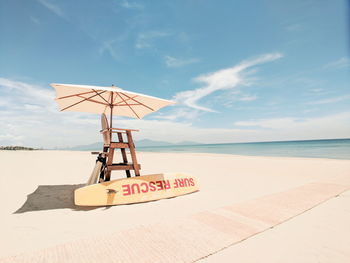 Lifeguard hut on beach against sky