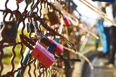 Close-up of colourful padlocks on metal fence in lisbon