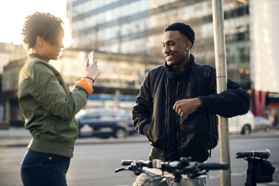 Young man standing in city