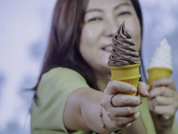 Midsection of woman holding ice cream