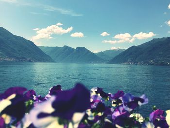 Scenic view of sea and mountains against sky