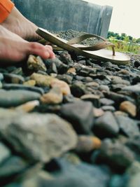 Midsection of person preparing food on pebbles