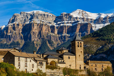 Buildings against mountain range