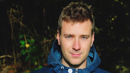 Close-up portrait of man against trees at forest