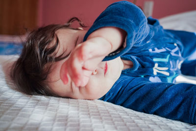 Cute baby girl on bed at home