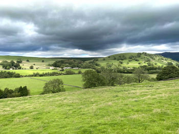 Yorkshire dales countryside, with fields, meadows,  and storm clouds near, burnsall, skipton, uk