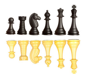 Low angle view of chess pieces against white background