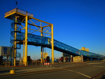 Low angle view of road against clear blue sky