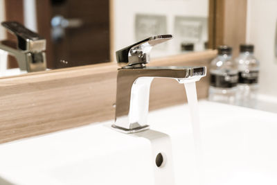 Close-up of faucet in bathroom