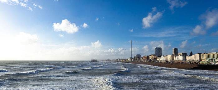 Panoramic view of sea and buildings against sky