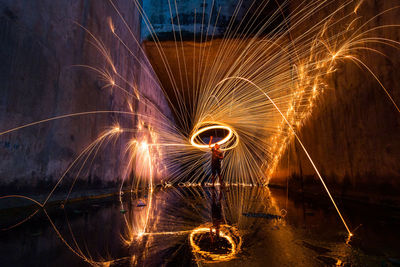 Firework display over river at night