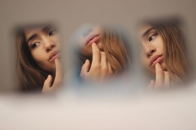 Reflection of woman touching lips