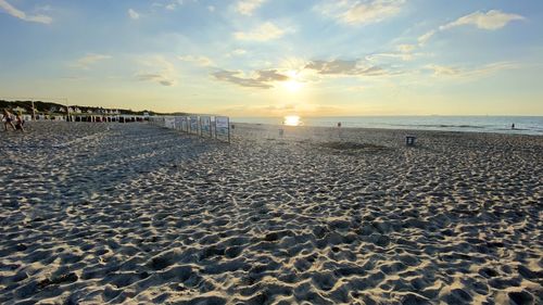 Scenic view of beach against sky during sunset