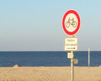 Warning sign on sea shore