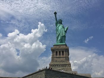 Low angle view of statue against cloudy sky