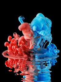 Close-up of blue water against black background