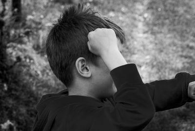 Side view of boy with fist