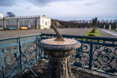 Close-up of railing by building against sky