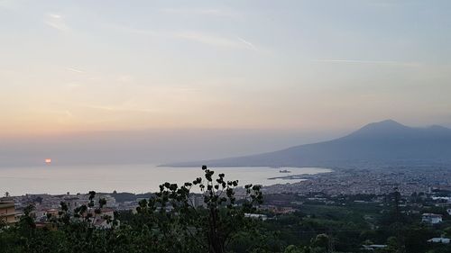 Scenic view of sea and cityscape against sky