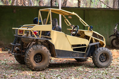 A yellow buggy is parked.