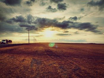 Scenic view of landscape against cloudy sky