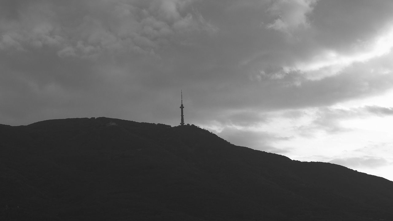 SILHOUETTE MOUNTAIN RANGE AGAINST CLOUDS