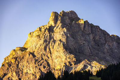 Low angle view of rock formations against clear sky