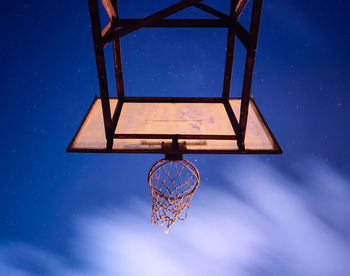 Low angle view of basketball hoop against blue sky