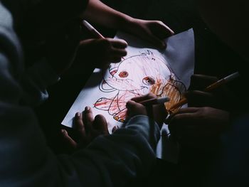 Midsection of person holding paper