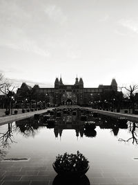 Bridge over river against buildings in city