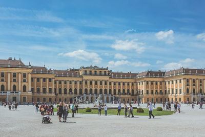 Group of people in park against buildings in city